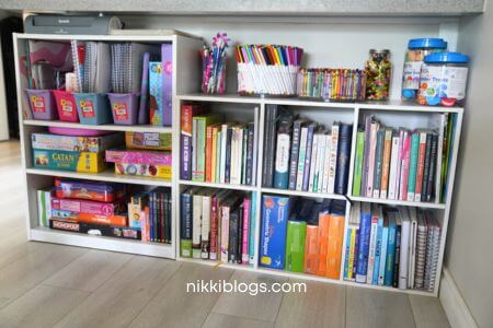 small homeschool room shelving under kitchen counter