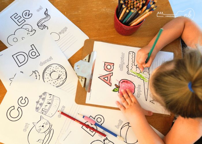 preschool student working on alphabet worksheets
