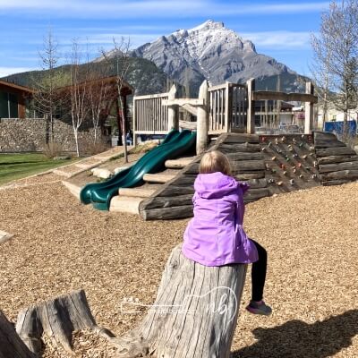 kid at the park during a stop on a road trip