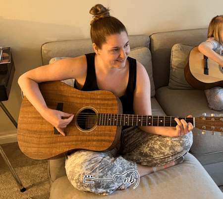 woman playing best beginner guitar martin d-x1e koa