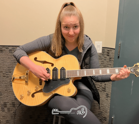 woman playing electric epiphone guitar