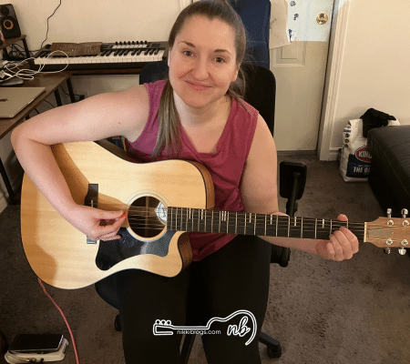 woman playing acoustic guitar