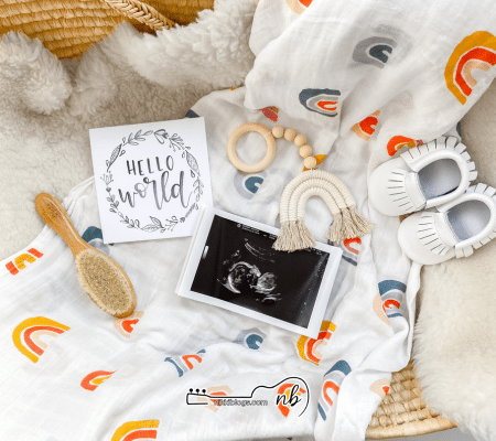 double rainbow baby pregnancy announcement with ultrasound, rainbow blanket, and rainbow toys