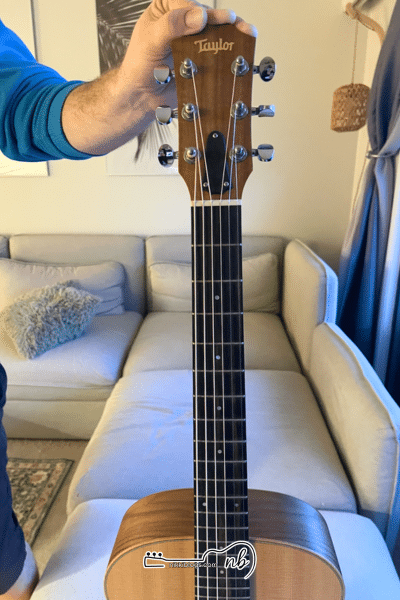 man holding up guitar from straight on point of view like a guitar chord chart