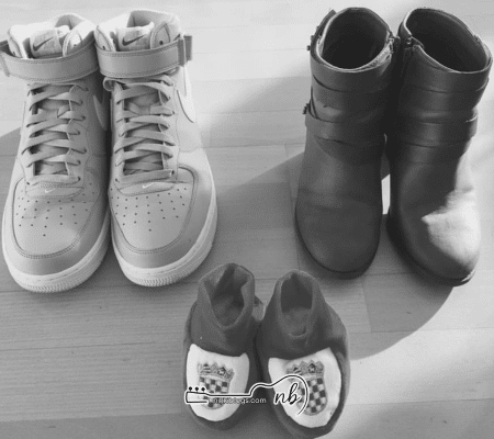 three pairs of shoes together pregnancy announcement idea - one for dad, one for mom, one for baby