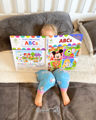 toddler flipping through a board book