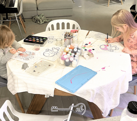 two girls enjoying preschool painting activity